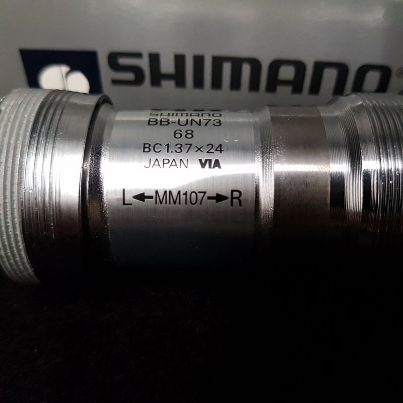 Bottom bracket axle N.O.S "SHIMANO BBUN 73" 107 mm 1.37 x 24 (Ref 479)